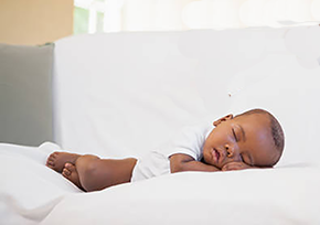 Baby laying on couch on his tummy